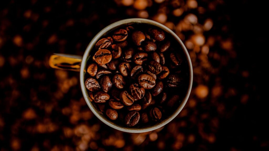 coffee beans scooped into a mug